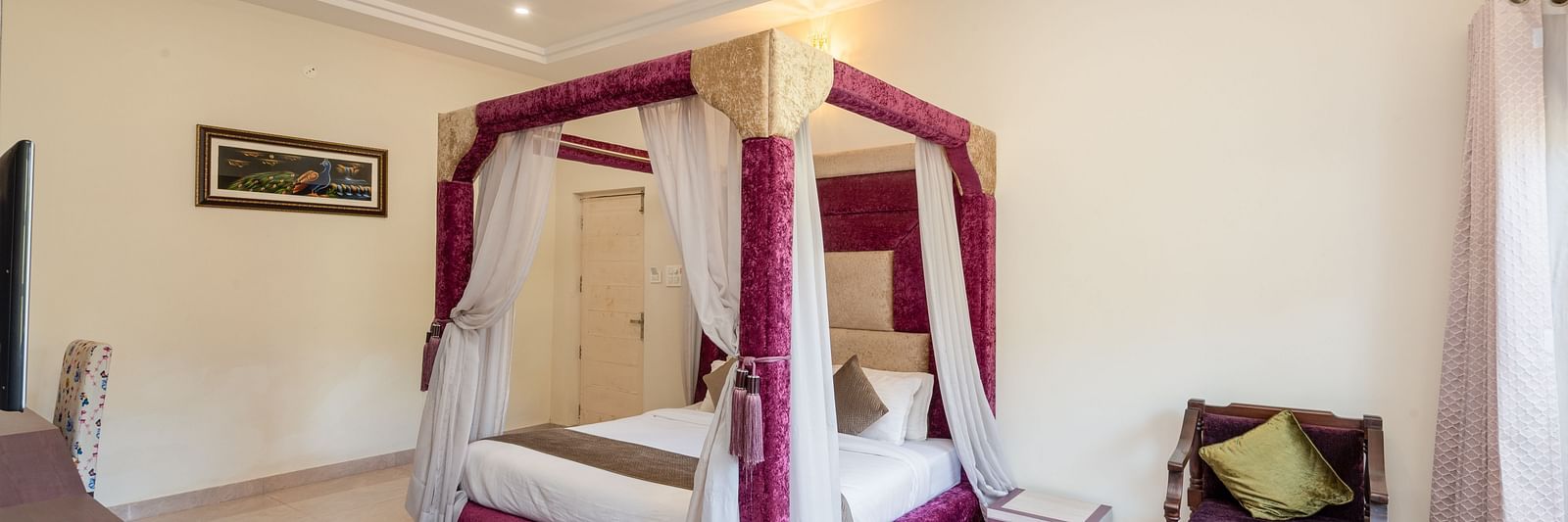 Luxurious bedroom at DLS Tehri Club Resort with a four-poster bed and elegant decor